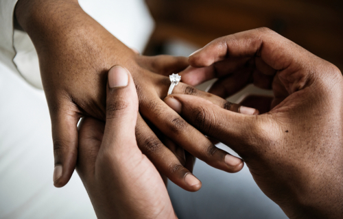person putting a ring on a partners finger