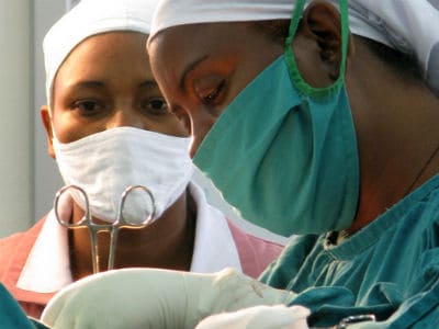 Doctors on an operating table with tools in hand