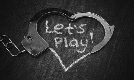 Handcuffs forming a heart, indicating BDSM/kink