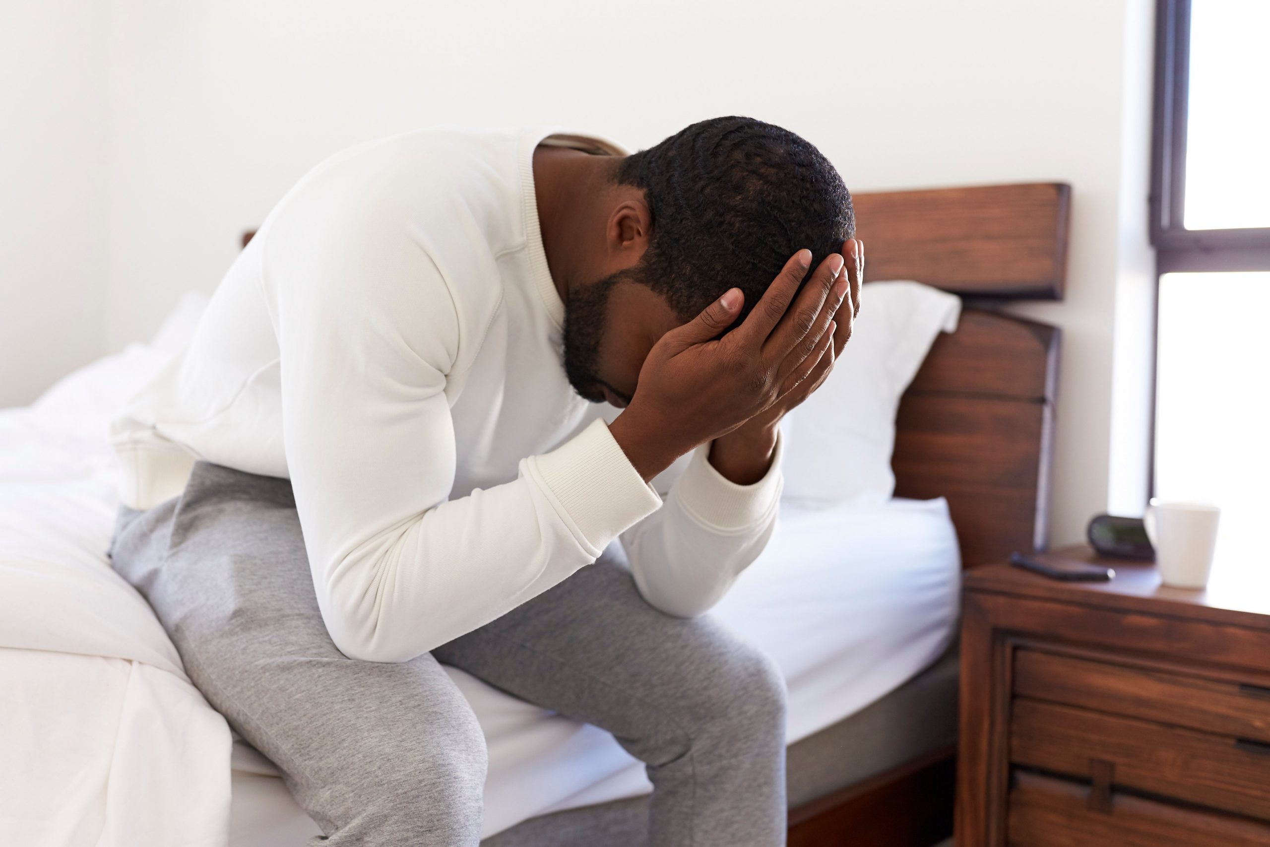 stressed man burying head in hands