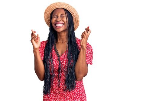 black woman gesturing finger crossed smiling with hope and eyes closed
