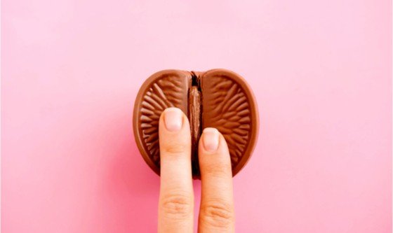 Fingers on chocolate organge representing female masturbation 