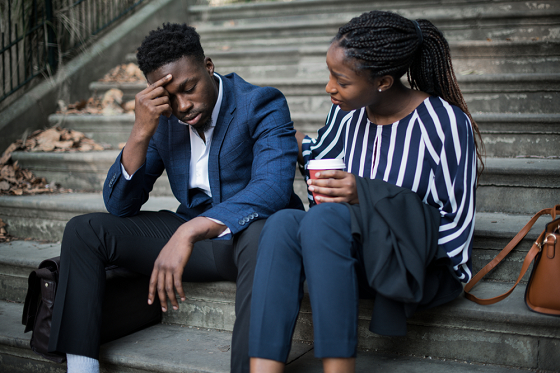 woman and stressed man sitting on stairs