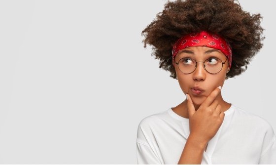 Woman with an afro thinking