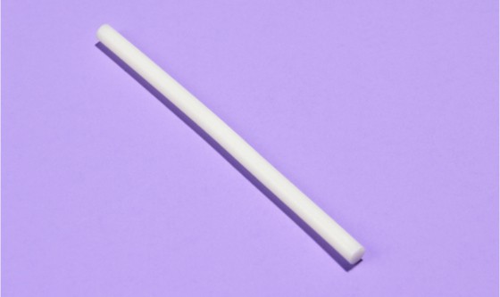 a white implant rod laid over a purple surface