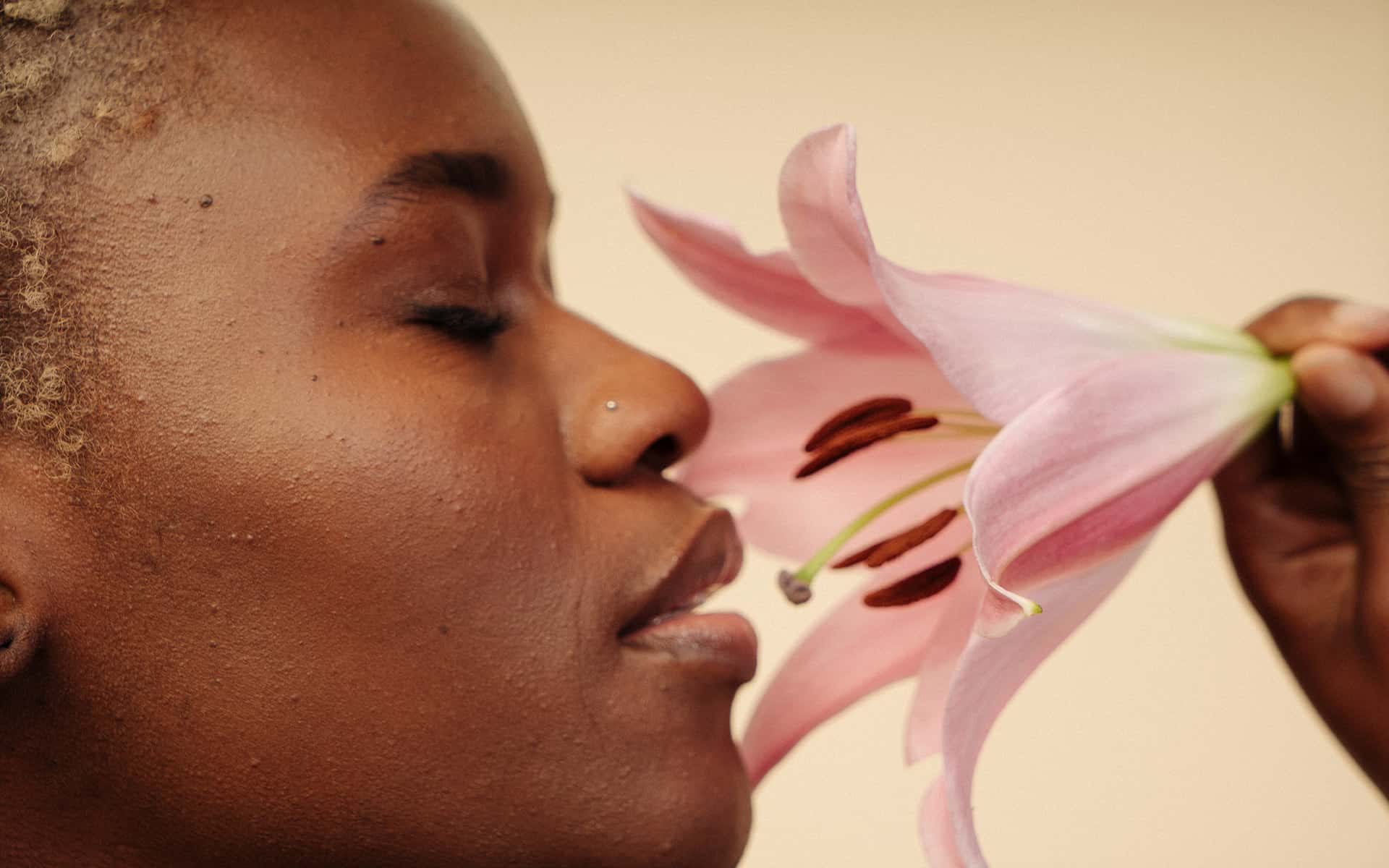 Woman sniffing flower 