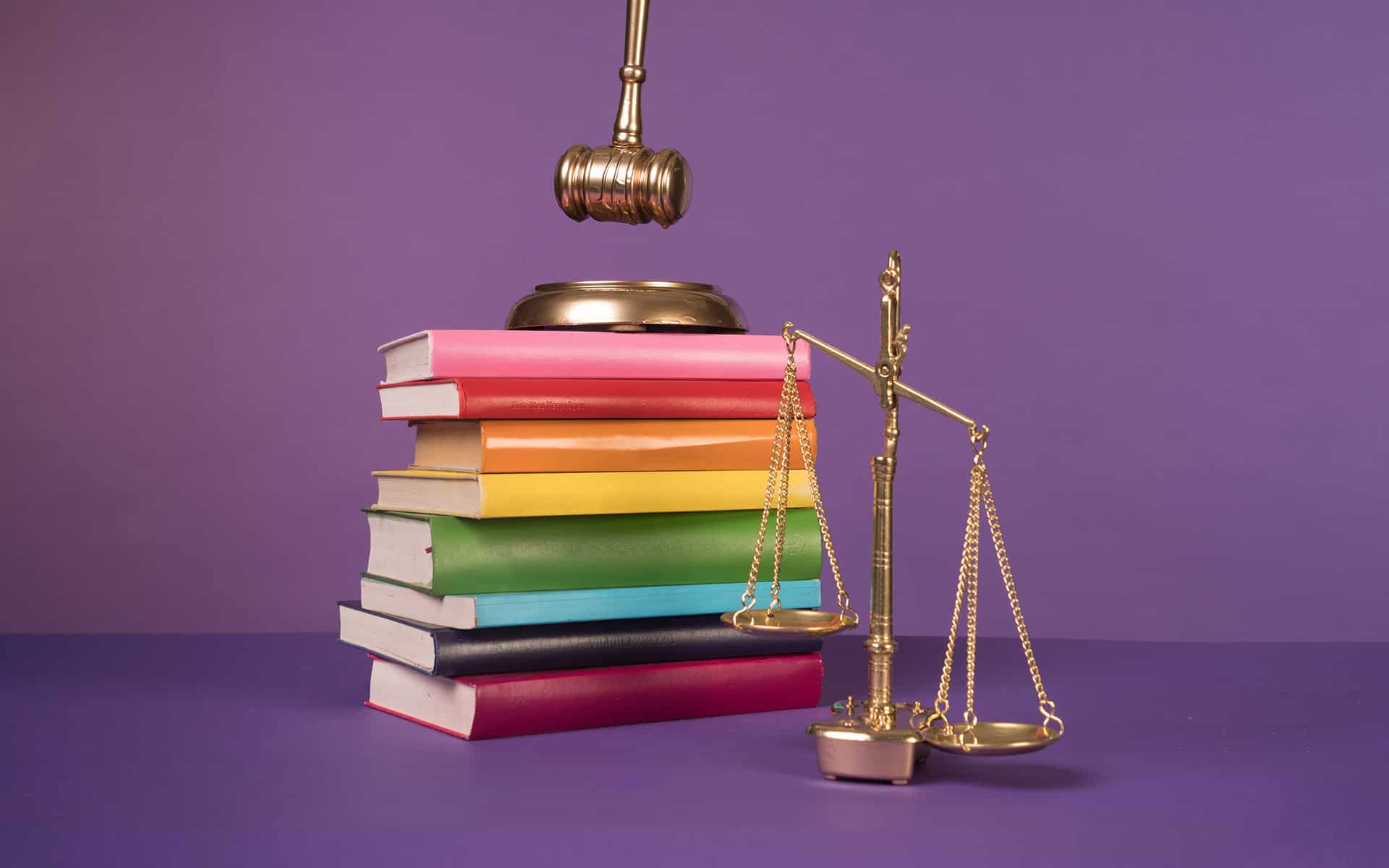Books in rainbow colours and the scales of justice 