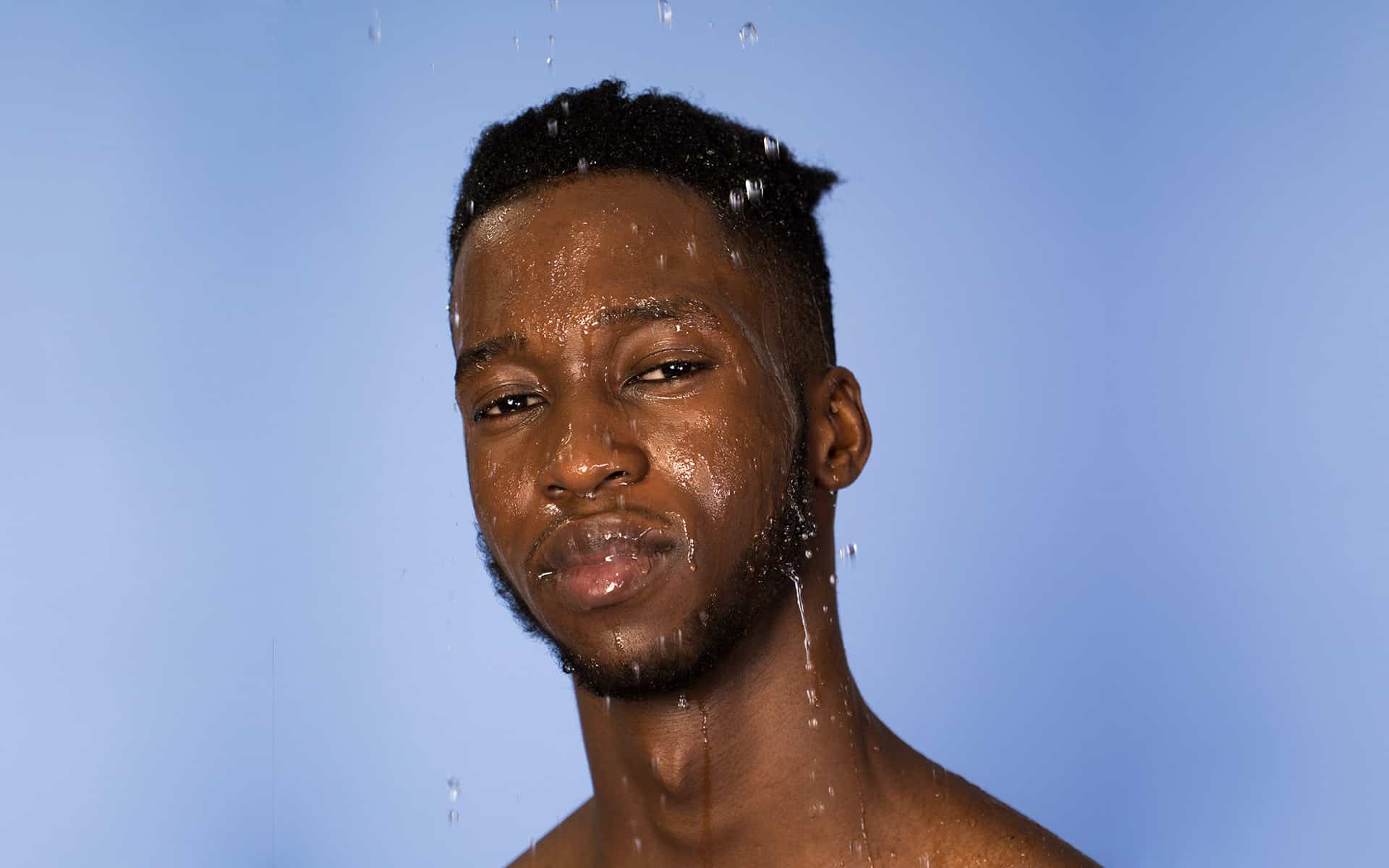 Man with his head wet, as if he has stepped out of the shower