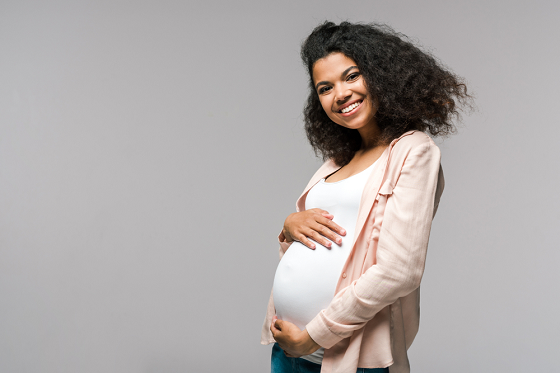 Pregnant woman holding her tummy