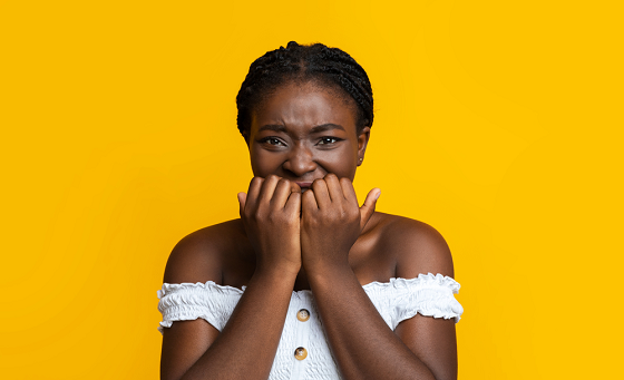 scared woman biting her fingers