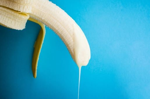 banana with white thick fluid dripping from tip to represent penis and semen