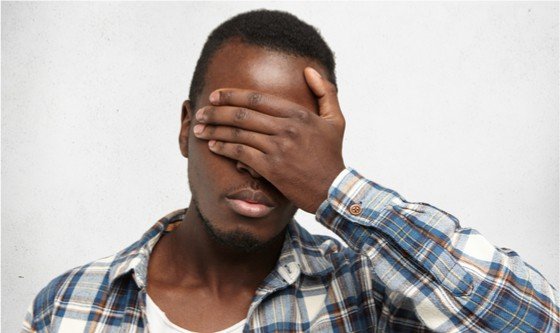 Man covering his eyes in shame because of premature ejaculation