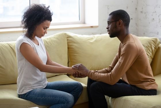 Man comforting a sad woman