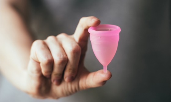 Young woman holding menstrual cup