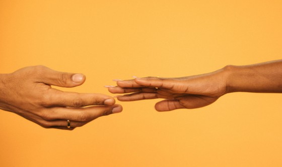 Married couple's hands drifting away from each other