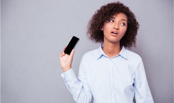 Woman holding up her phone in distress