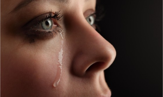 Woman with green eyes crying 