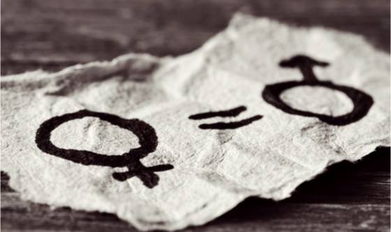 a female symbol, an equals sign and a male symbol drawn on a piece of paper depicting the women equality