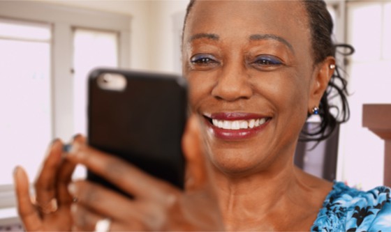 Woman happily looking at her phone 
