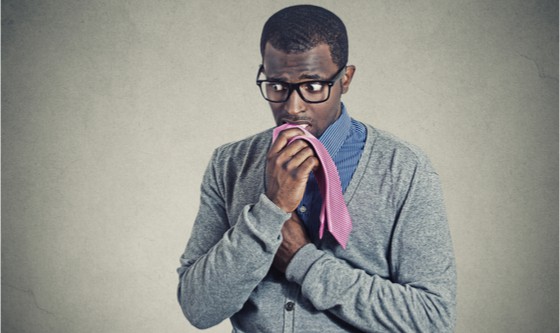 Anxious man chewing on his tie 