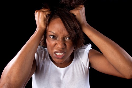 a woman pulls her hair in frustration