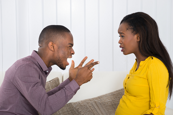 Man shouting at scared woman