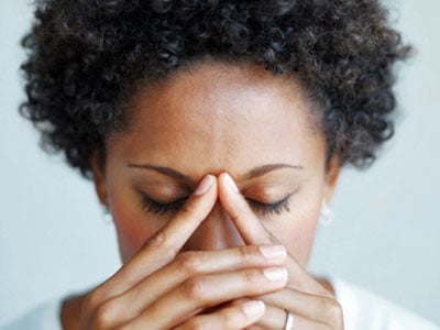 woman bowing and looking worried