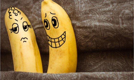 Two bananas in bed, one happy, one annoyed