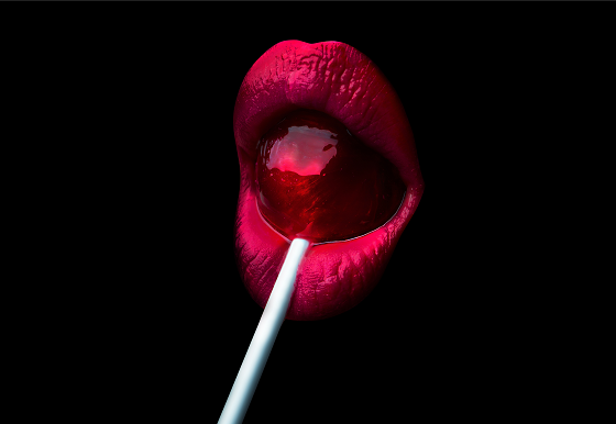 red lips eating a red lory pop