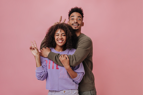 man hugging woman from behind