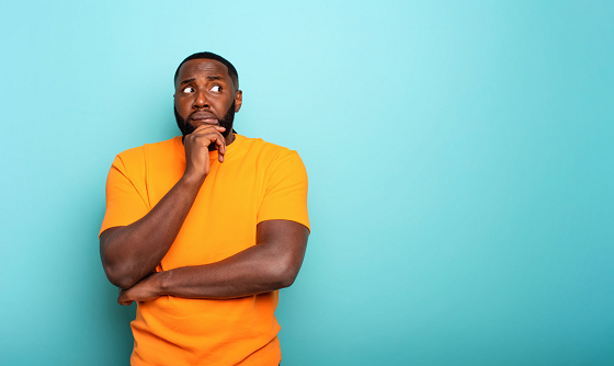 scared african man with orange shirt