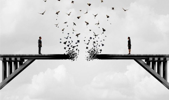 A man and a woman standing on a fading bridge