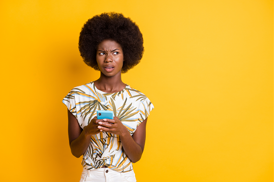 Confused woman holding phone