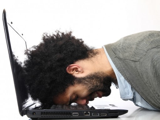 Depressed man collapsed on his laptop