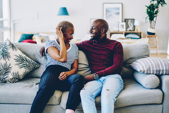 black man and woman smiling at each other 