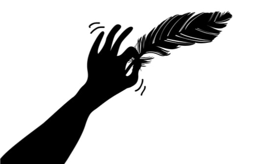 Hand holding a feather making a tickling motion
