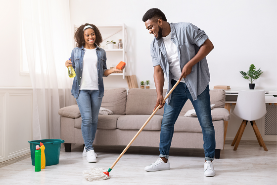 man mopping floor as woman watches