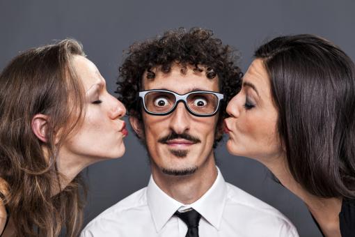 Two women kissing one man between them