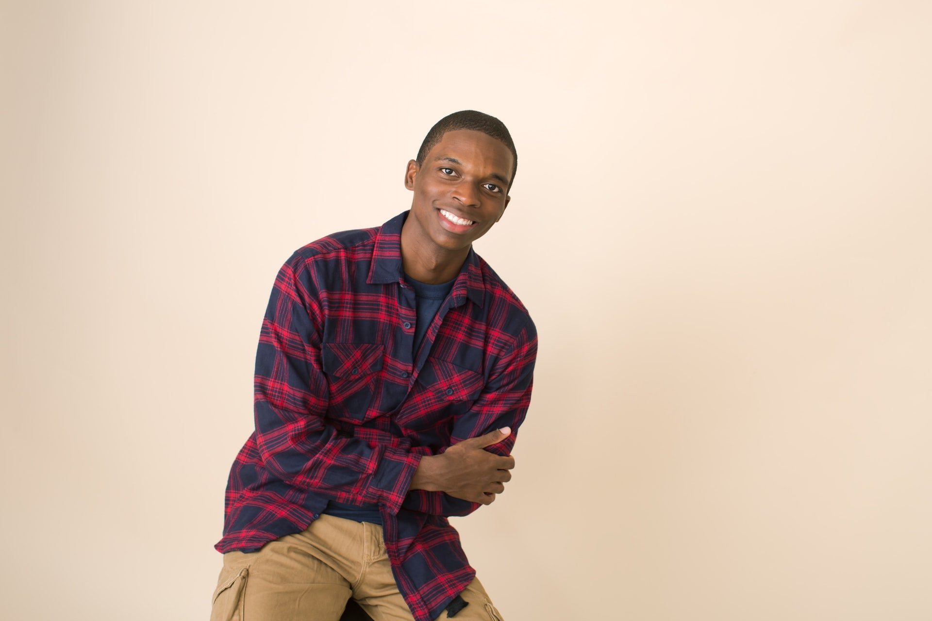 A young black man smiling at the camera