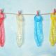 used colored condoms hanged on a hanging line