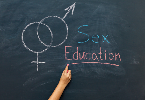 Black board written sex education and intersecting gender signs