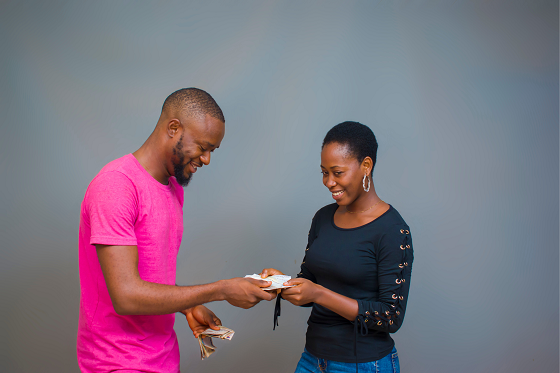 man giving woman money