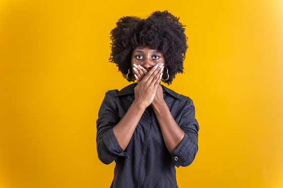 Woman covering her mouth with both hands