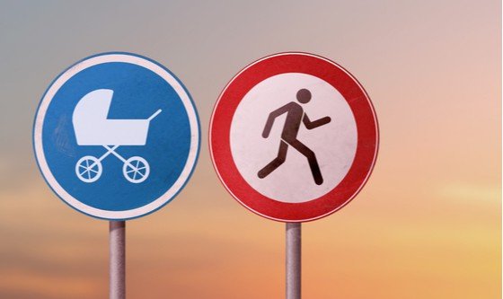 Graphic of a man on a sign going in the other direction from another sign with a stroller on it