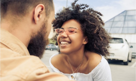 Young happy couple in a parking lot