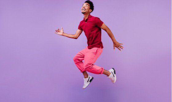 Black man jumping excitedly into the air