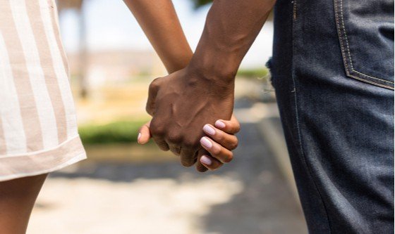 The hands of a couple clasped together