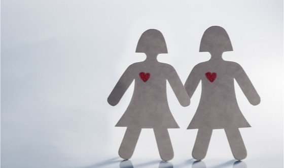 Paper cut-out of two women holding hands 