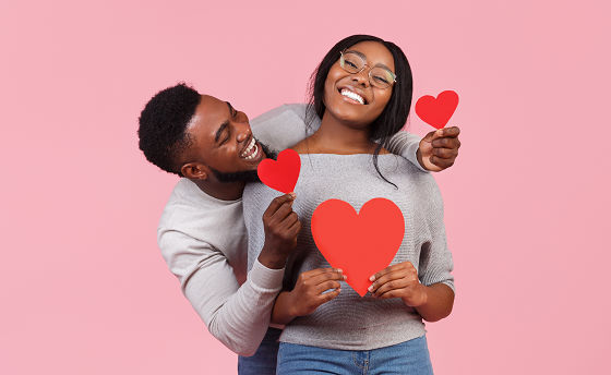 happy couple holding red love hearts 