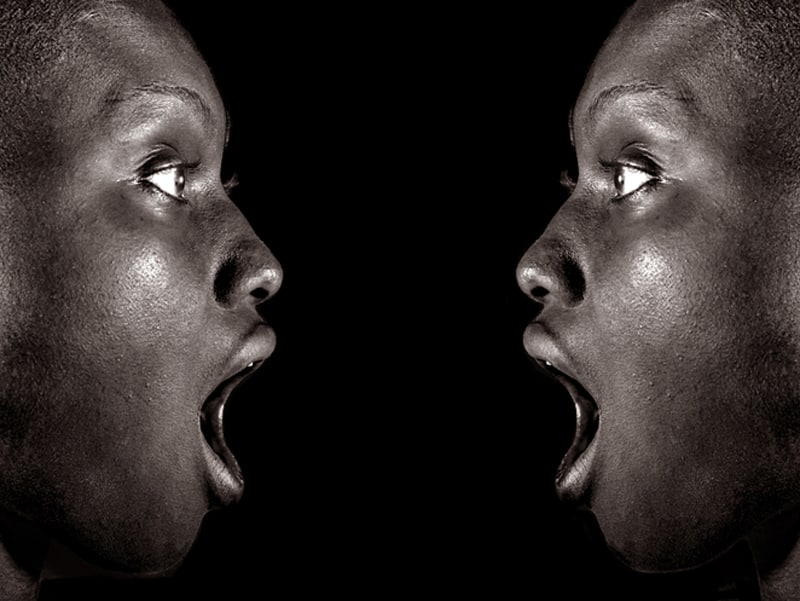 mirrored image of man with mouth wide open in shock